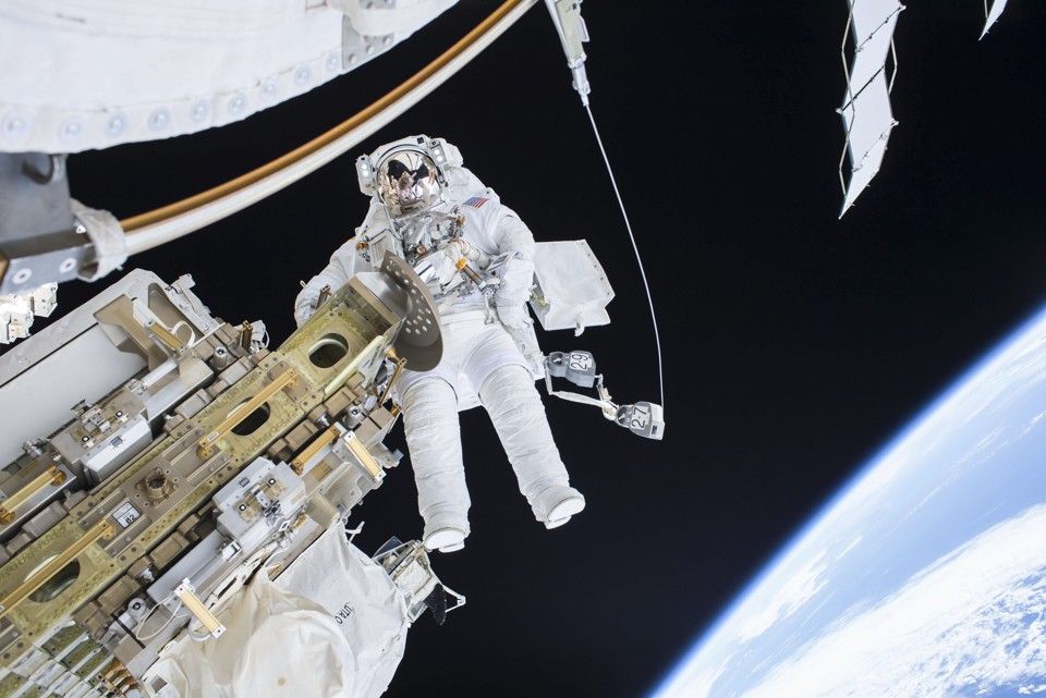 Expedition 46 Flight Engineer Tim Kopra performs a spacewalk outside the International Space Station in this December 21, 2015 NASA handout photo. Kopra and Expedition 46 Commander Scott Kelly successfully moved the International Space Station's mobile transporter rail car ahead of the December 23, 2015 docking of a Russian cargo supply spacecraft.  REUTERS/NASA/Handout via Reuters THIS IMAGE HAS BEEN SUPPLIED BY A THIRD PARTY. IT IS DISTRIBUTED, EXACTLY AS RECEIVED BY REUTERS, AS A SERVICE TO CLIENTS. FOR EDITORIAL USE ONLY. NOT FOR SALE FOR MARKETING OR ADVERTISING CAMPAIGNS - RTX1ZSVJ