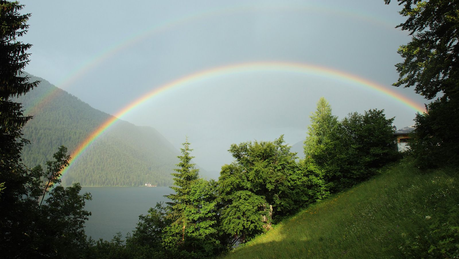 A double rainbow appears above Lake Weissensee in Naggl in Austria's southern Carinthia province July 10, 2013. REUTERS/Heinz-Peter Bader  (AUSTRIA - Tags: TRAVEL ENVIRONMENT SOCIETY)  - RTX11J42